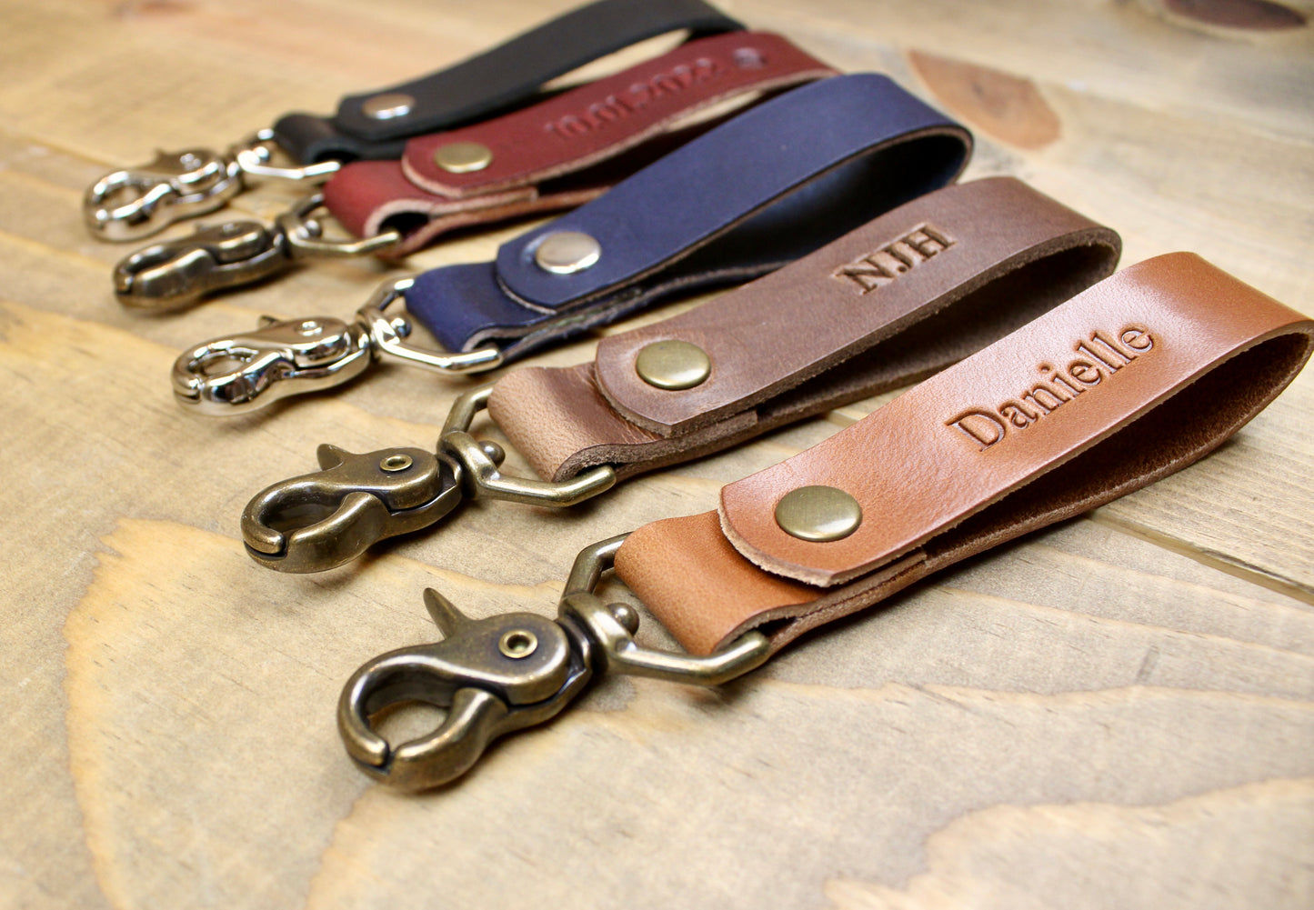Premium leather keychain with a snap button closure, combining durability and elegance for a sleek, functional accessory.