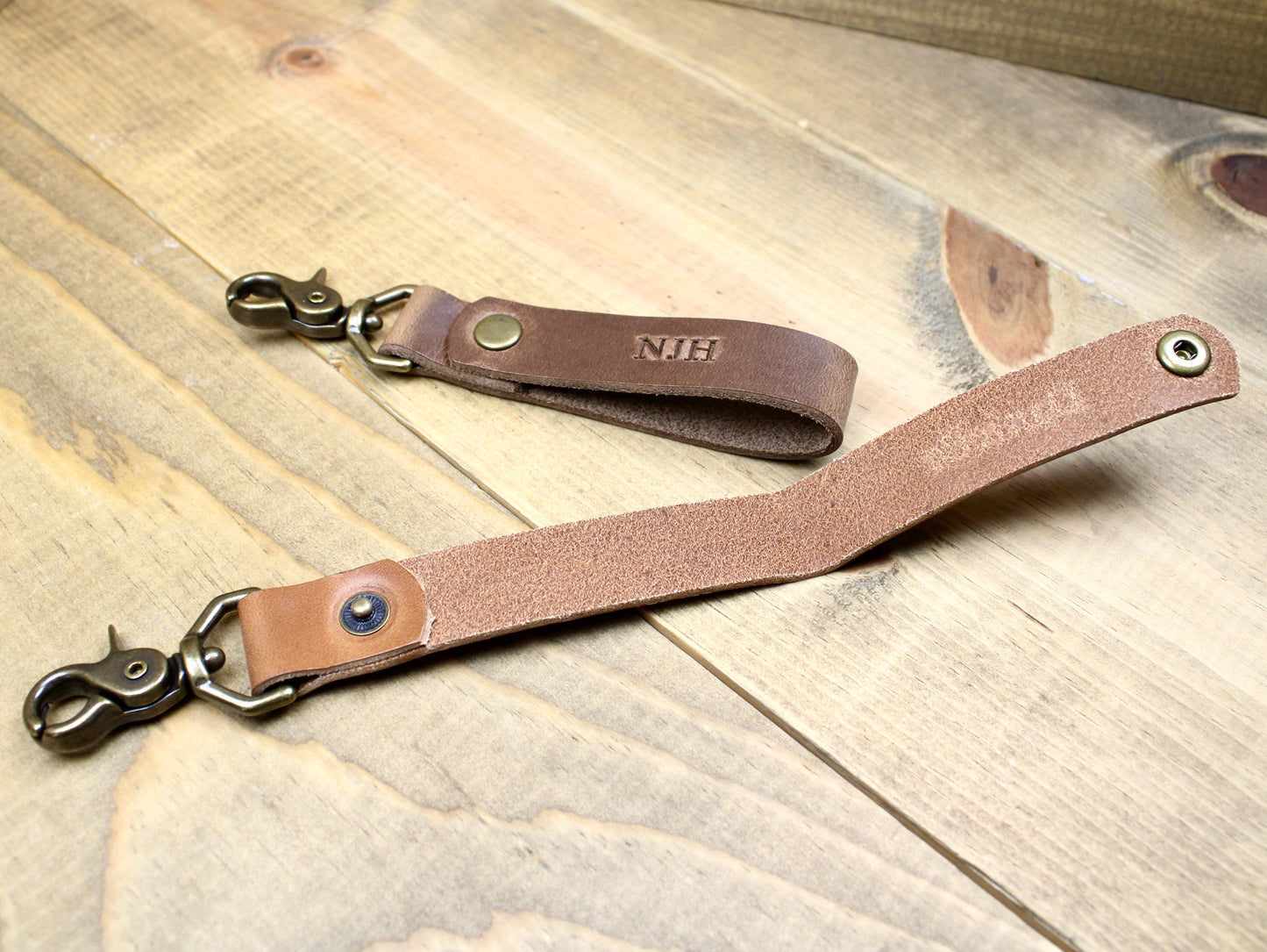 Premium leather keychain with a snap button closure, combining durability and elegance for a sleek, functional accessory.