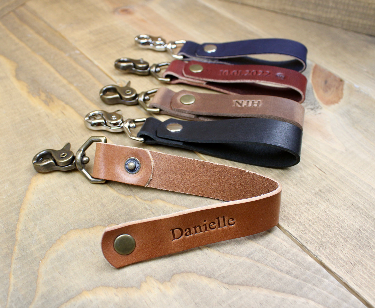 Handmade leather keychain with snap button. Choose between Buck Brown, Brown, Black, Navy Blue, Burgundy, or Navy blue leather with either Silver or Antique Brass hardware.