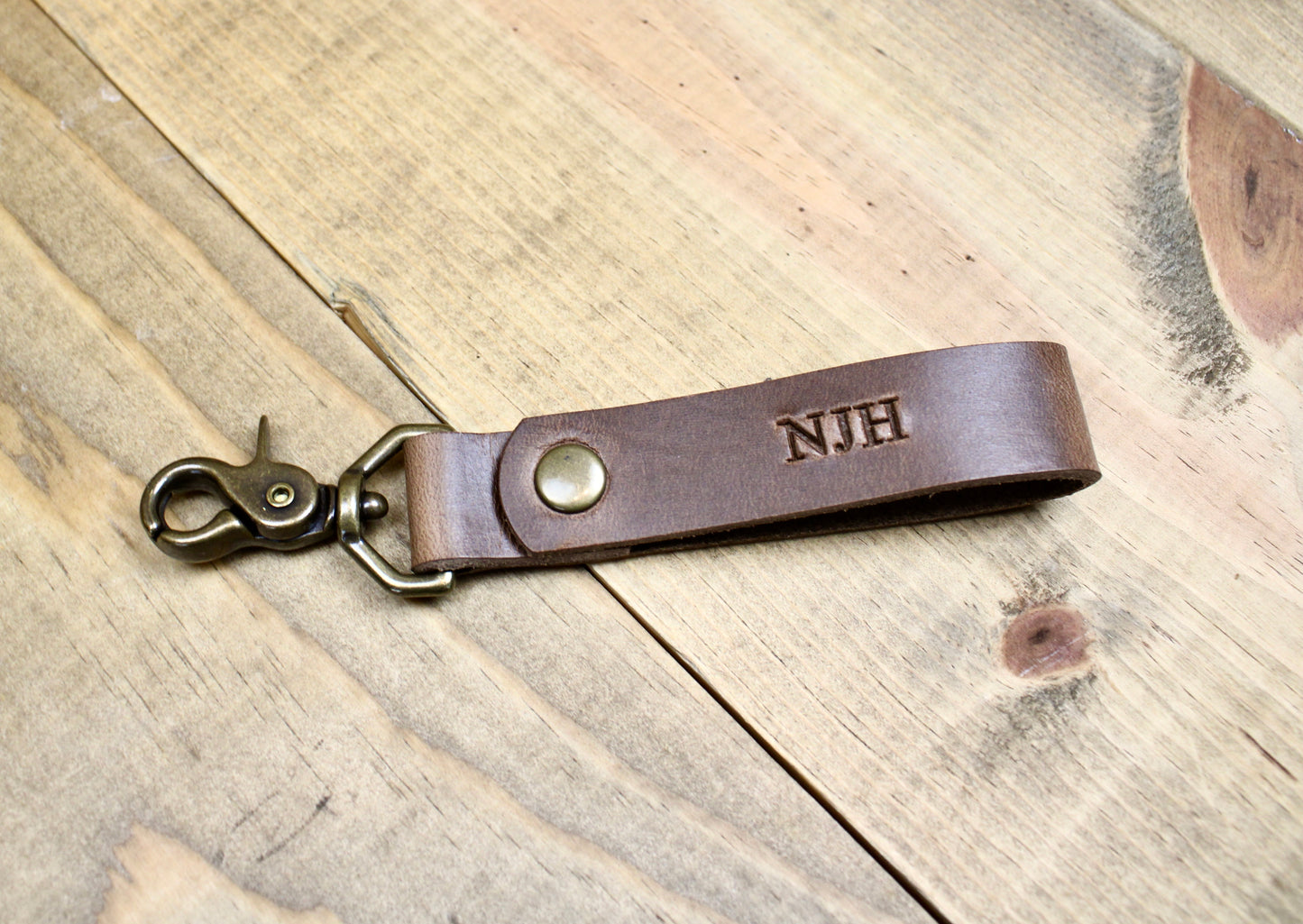 Brown Premium leather keychain with a snap button closure, combining durability and elegance for a sleek, functional accessory.
