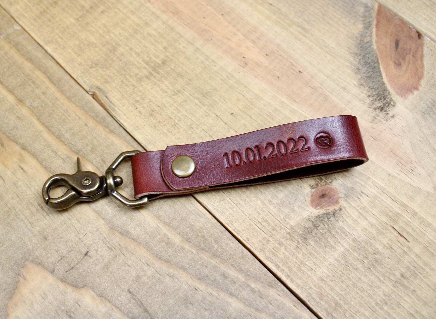 Burgundy Premium leather keychain with a snap button closure, combining durability and elegance for a sleek, functional accessory.