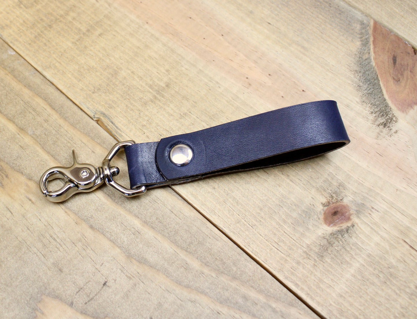 Navy Blue Premium leather keychain with a snap button closure, combining durability and elegance for a sleek, functional accessory.