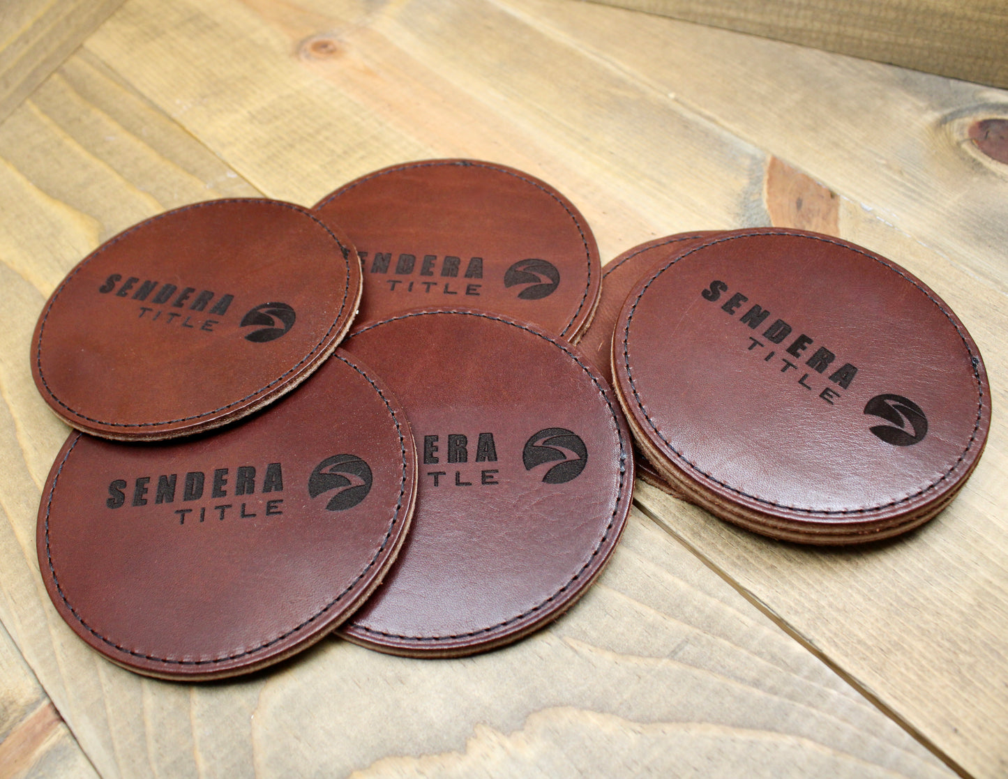 Customized leather coasters featuring intricate laser engraving and premium craftsmanship, perfect for adding a personalized touch to any tabletop.