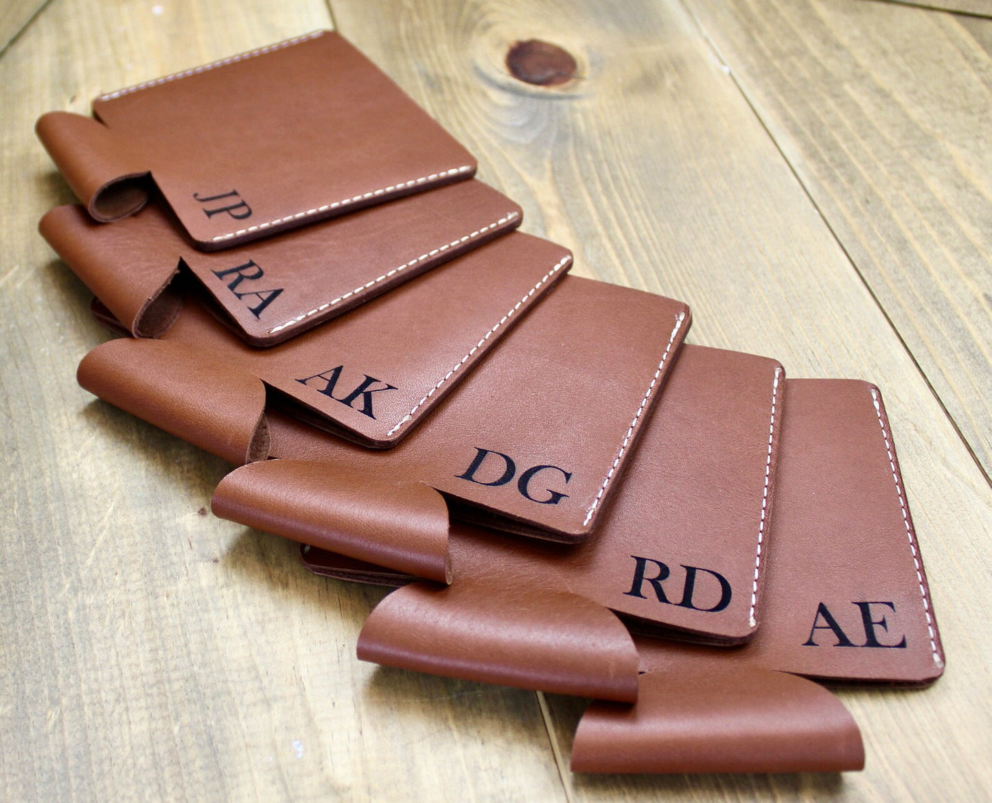 Brown personalized leather can coolers with custom engraving, featuring a stylish and durable design to keep drinks cold in style.