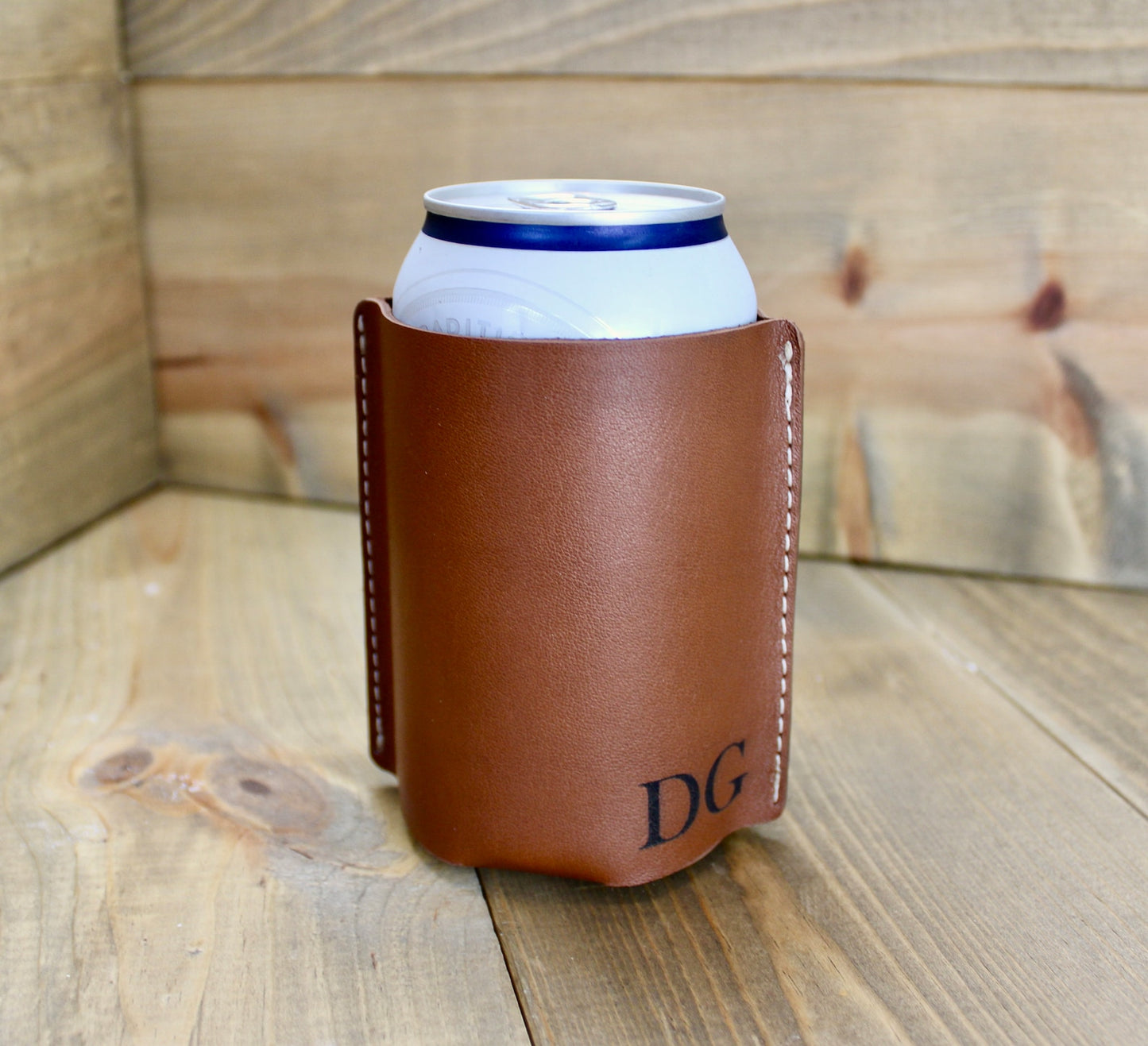Brown personalized leather can coolers with custom engraving, featuring a stylish and durable design to keep drinks cold in style.