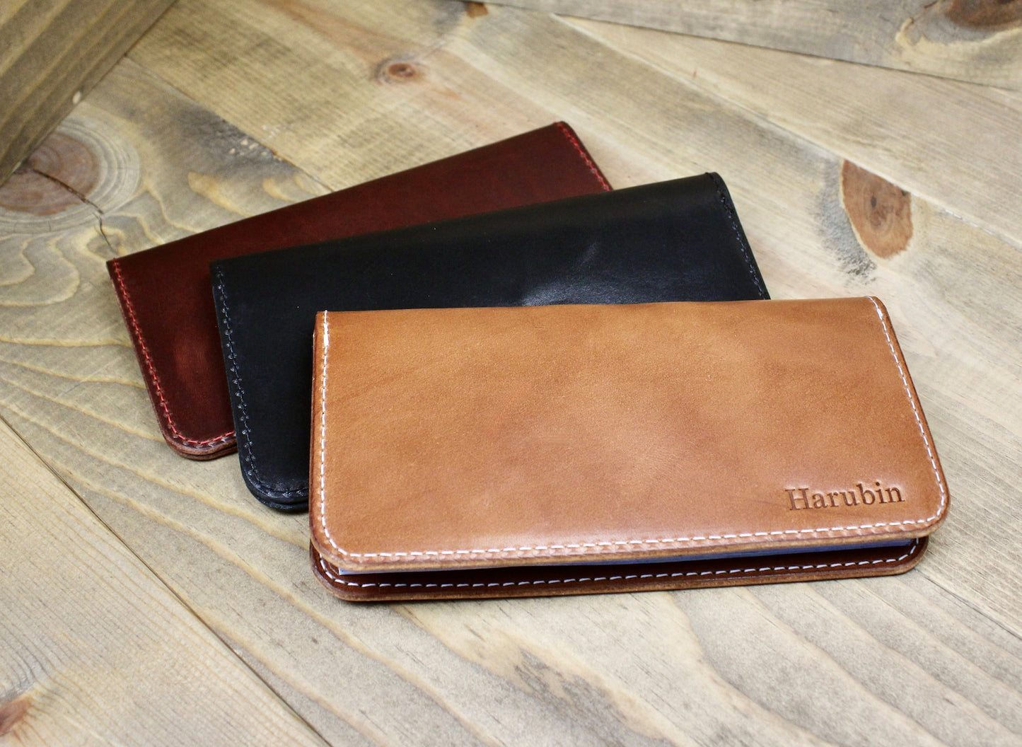 Elegant leather checkbook holder with a sleek design, durable stitching, and spacious compartments for checks, cards, and essentials.