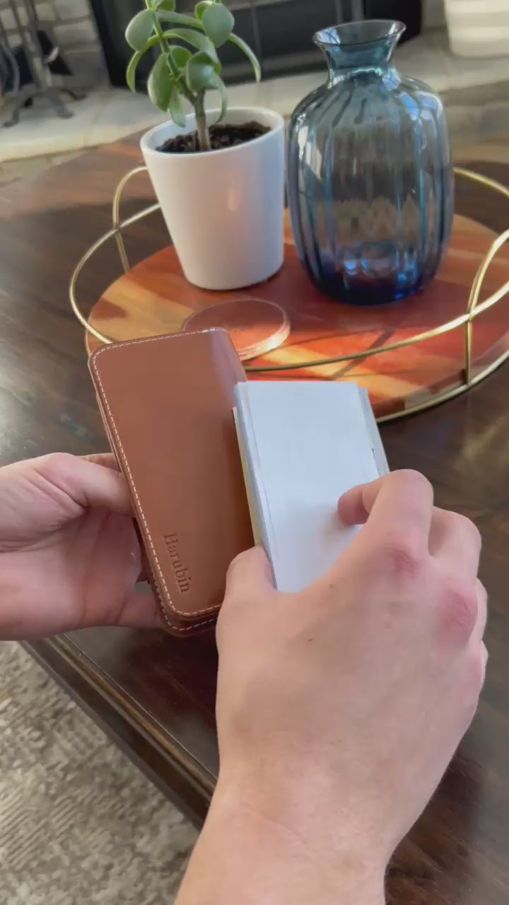 Sophisticated black leather checkbook holder with a smooth finish, durable construction, and convenient storage for checks and cards.