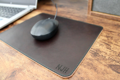 Toasted wheat personalized leather mousepad with cream thread laser engraved with initials in the bottom right hand corner.