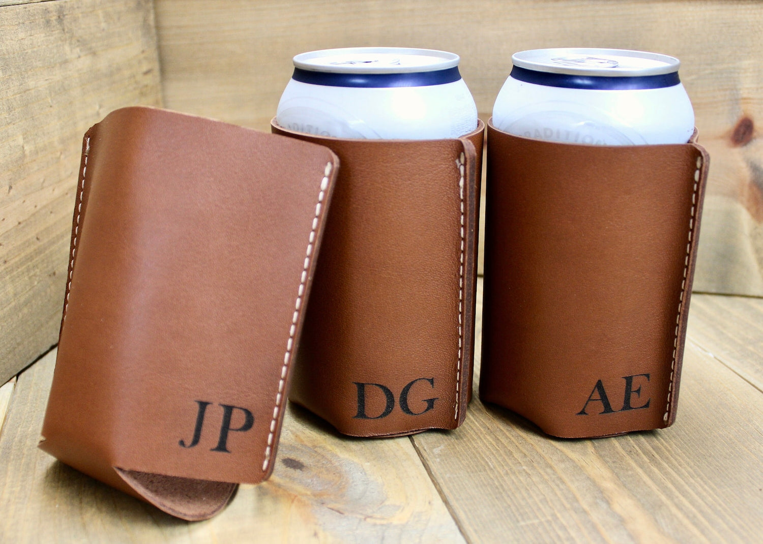 Brown personalized leather can coolers with custom engraving, featuring a stylish and durable design to keep drinks cold in style.