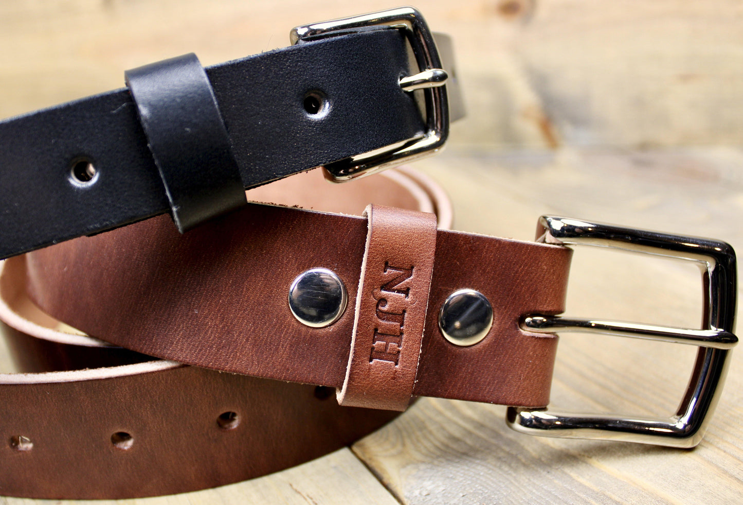Black 1" Leather Belt on top of a Medium Brown 1.5" leather belt