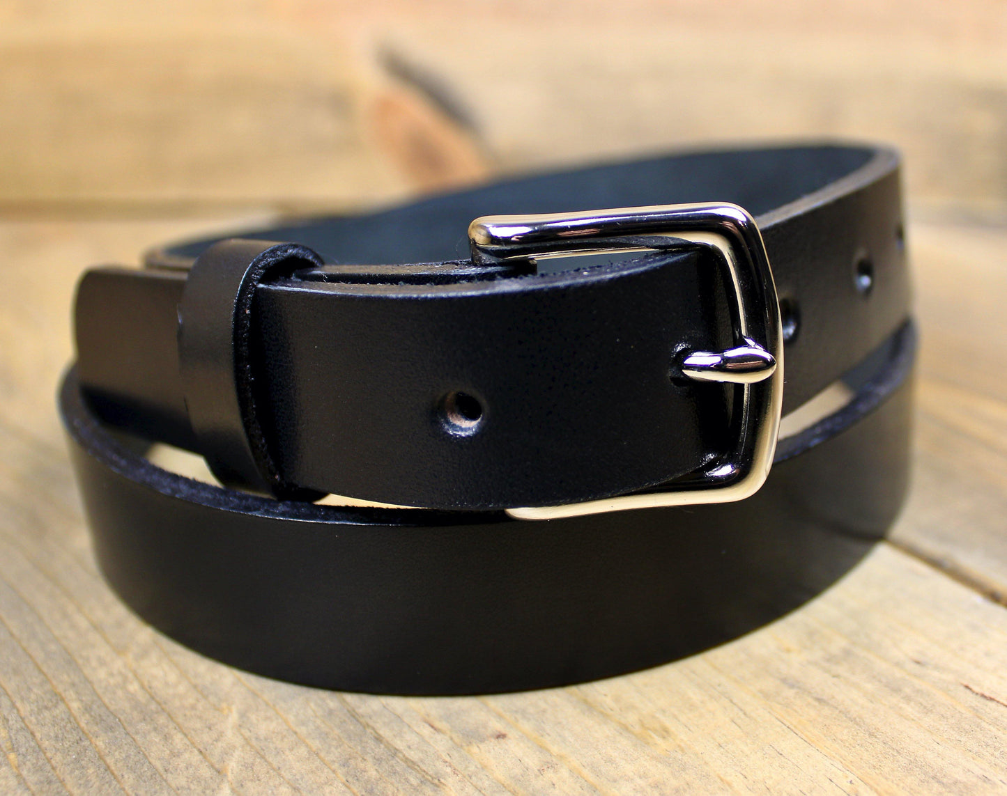 Close up on a 1" Black Leather Belt and Silver 1" Buckle